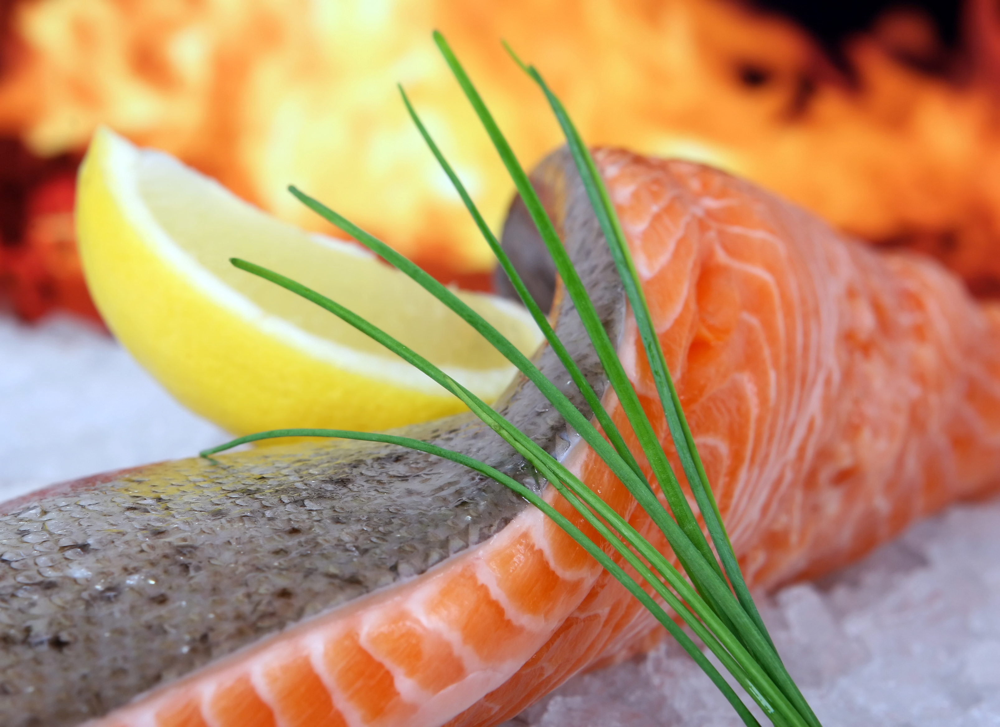 Rose colored fish steak, summer food with wine and lemon marinade macro closeup